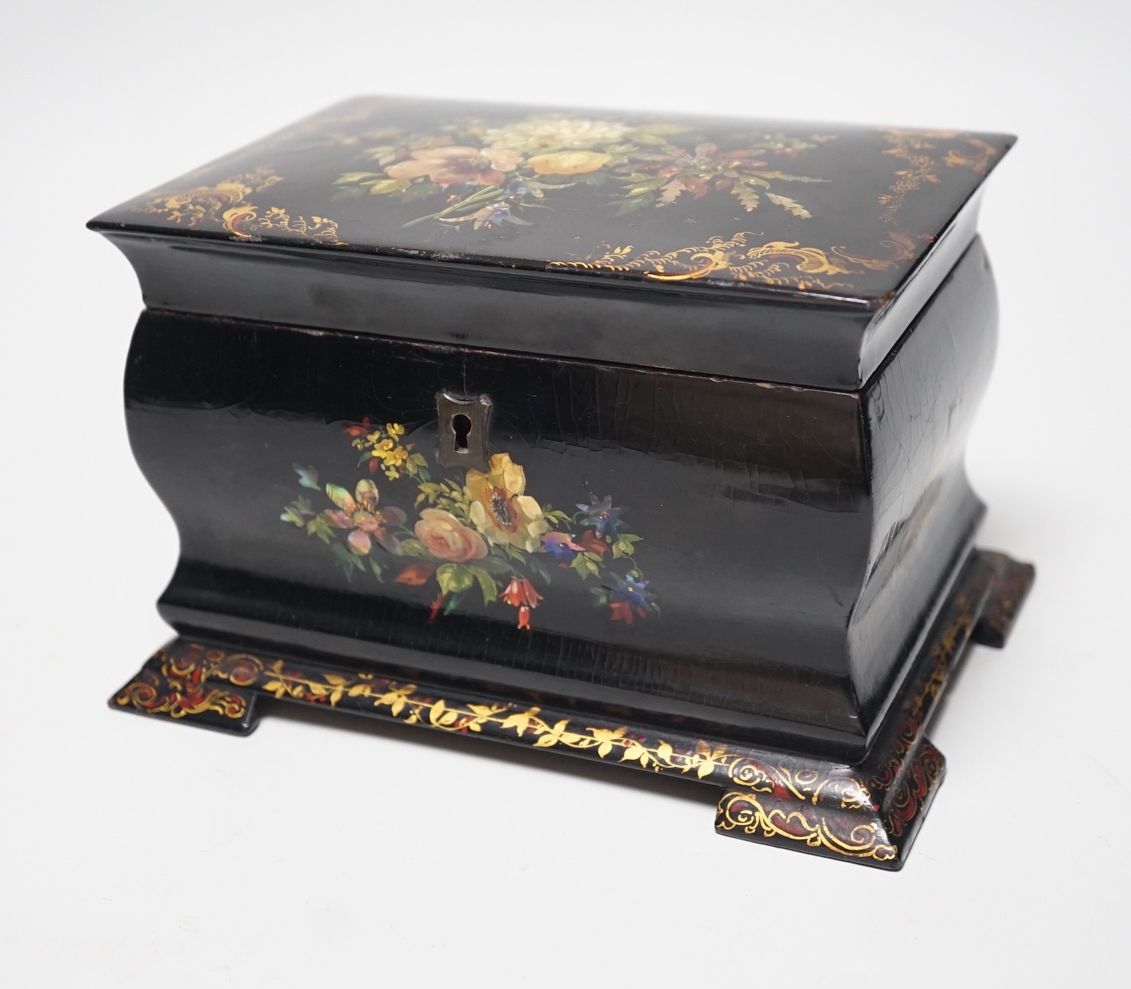 A Victorian papier-mâché bombé tea caddy with painted floral and gilt decoration. 12.5cm high